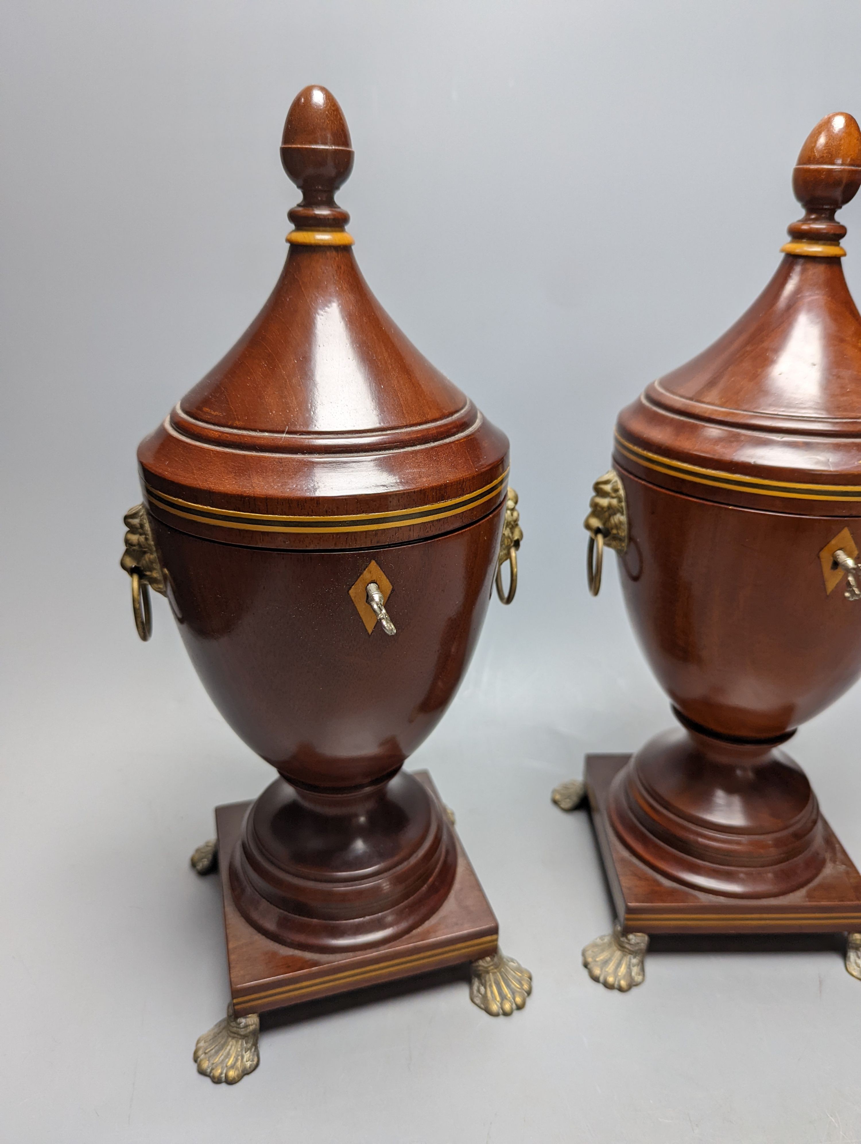 A pair of Sheraton-style mahogany urn-shape tea caddies, with brass mounts, 36cm.